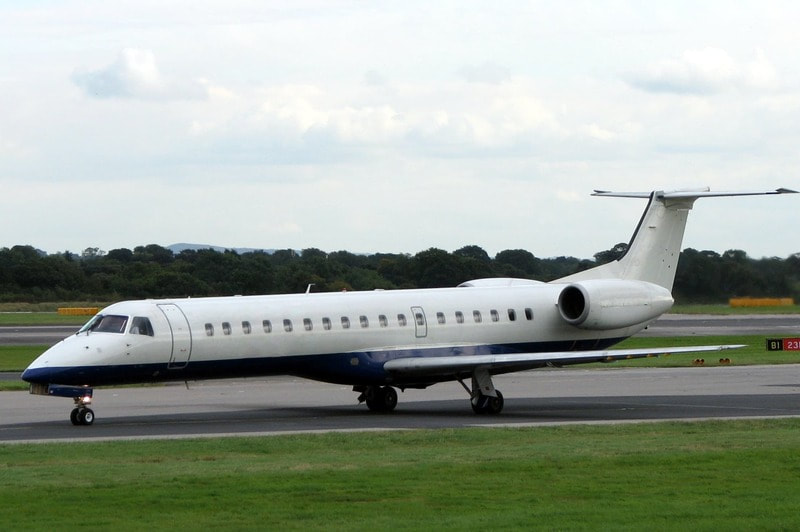 White Embraer E145 taxiing